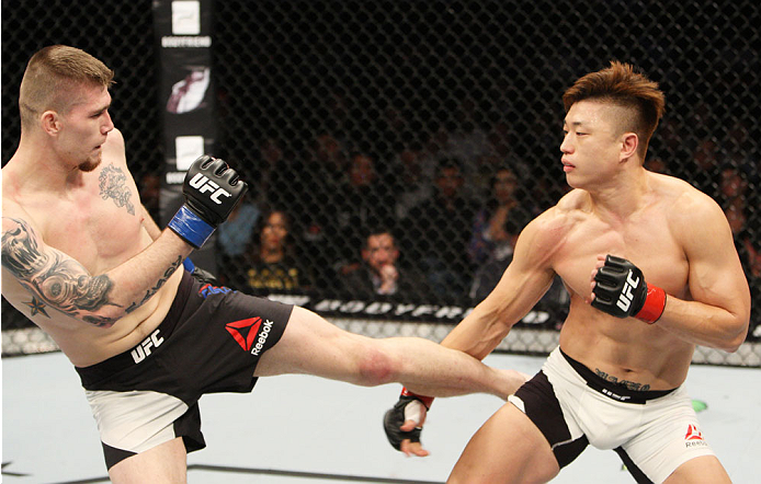 SEOUL, SOUTH KOREA - NOVEMBER 28: Jake Collier of the United States of America kicks Dongi Yang of South Korea in their middleweight bout during the UFC Fight Night at the Olympic Park Gymnastics Arena on November 28, 2015 in Seoul, South Korea. (Photo b