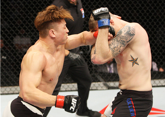 SEOUL, SOUTH KOREA - NOVEMBER 28: Dongi Yang of South Korea punches Jake Collier of the United States of America in their middleweight bout during the UFC Fight Night at the Olympic Park Gymnastics Arena on November 28, 2015 in Seoul, South Korea. (Photo