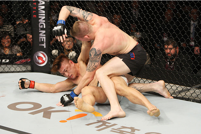 SEOUL, SOUTH KOREA - NOVEMBER 28: Jake Collier of the United States of America throws punches at Dongi Yang of South Korea in their middleweight bout during the UFC Fight Night at the Olympic Park Gymnastics Arena on November 28, 2015 in Seoul, South Ko