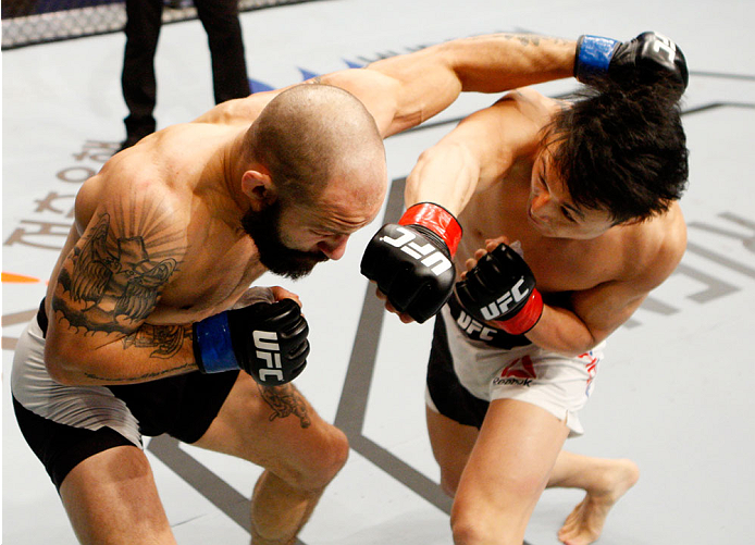 SEOUL, SOUTH KOREA - NOVEMBER 28: Doo Ho Choi of South Korea punches Sam Sicilia of the United States of America in their featherweight bout during the UFC Fight Night at the Olympic Park Gymnastics Arena on November 28, 2015 in Seoul, South Korea. (Phot