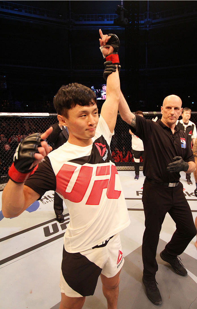 SEOUL, SOUTH KOREA - NOVEMBER 28: Doo Ho Choi of South Korea has his hand raised after his win over Sam Sicilia of the United States of America in their featherweight bout during the UFC Fight Night at the Olympic Park Gymnastics Arena on November 28, 2