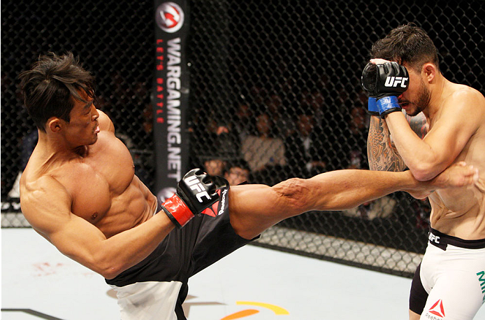 SEOUL, SOUTH KOREA - NOVEMBER 28: Yoshihiro Akiyama of Japan kicks Alberto Mina of Brazil in their welterweight bout during the UFC Fight Night at the Olympic Park Gymnastics Arena on November 28, 2015 in Seoul, South Korea. (Photo by Mitch Viquez/Zuffa