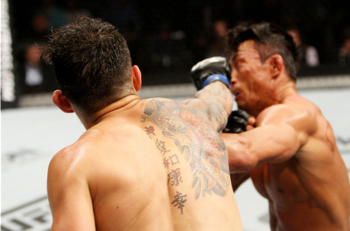SEOUL, SOUTH KOREA - NOVEMBER 28: Alberto Mina of Brazil throws a punch at Yoshihiro Akiyama of Japan in their welterweight bout during the UFC Fight Night at the Olympic Park Gymnastics Arena on November 28, 2015 in Seoul, South Korea. (Photo by Mitch V