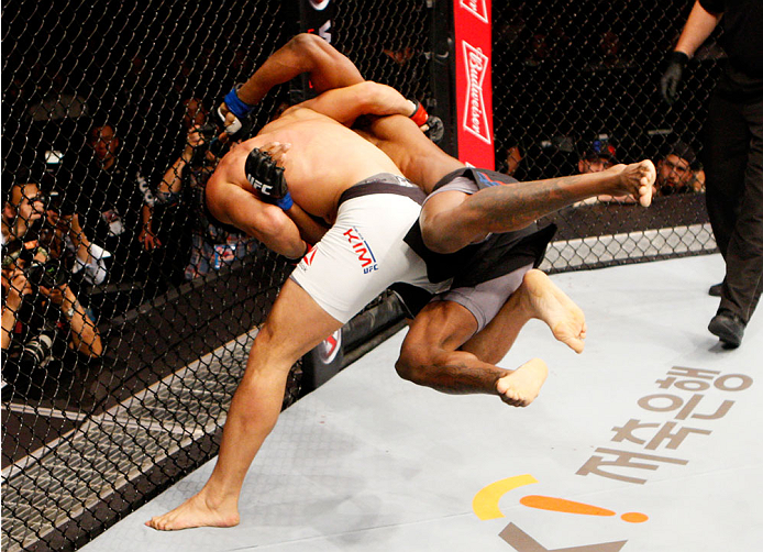 SEOUL, SOUTH KOREA - NOVEMBER 28: (From L to R) Dong Hyun Kim of South Korea takes down Dominic Waters of the United States of America grapple for control in their welterweight bout during the UFC Fight Night at the Olympic Park Gymnastics Arena on Nove
