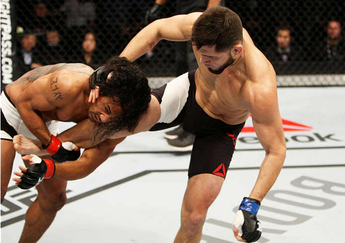 SEOUL, SOUTH KOREA - NOVEMBER 28: Benson Henderson of the United States of America throws a kick at Jorge Masvidal of the United States of America in their welterweight bout during the UFC Fight Night at the Olympic Park Gymnastics Arena on November 28, 2