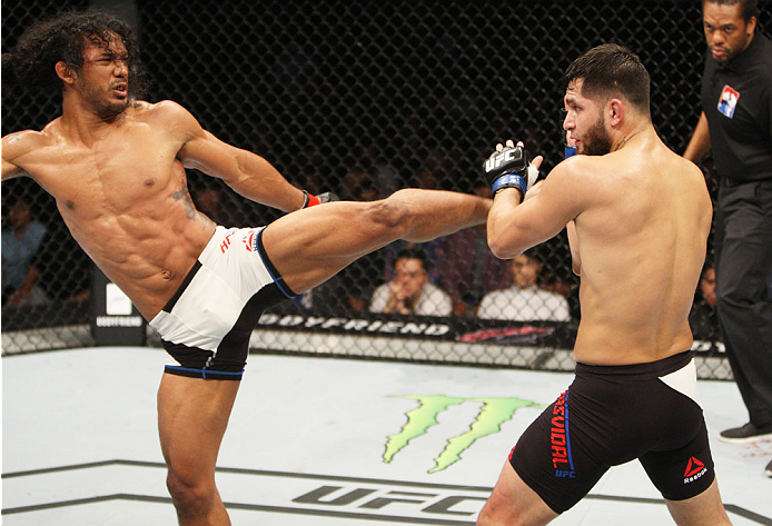 SEOUL, SOUTH KOREA - NOVEMBER 28: Benson Henderson of the United States of America throws a kick at Jorge Masvidal of the United States of America in their welterweight bout during the UFC Fight Night at the Olympic Park Gymnastics Arena on November 28, 2