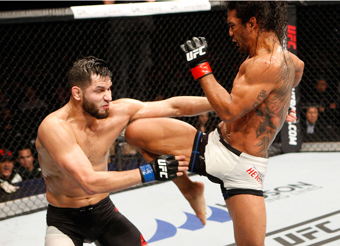 SEOUL, SOUTH KOREA - NOVEMBER 28: Benson Henderson of the United States of America throws a jumping knee at Jorge Masvidal of the United States of America in their welterweight bout during the UFC Fight Night at the Olympic Park Gymnastics Arena on Novemb