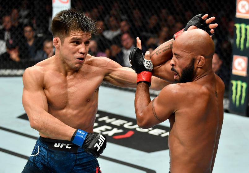 LOS ANGELES, CA - AUGUST 04: (L-R) Henry Cejudo punches Demetrious Johnson in their UFC flyweight championship fight during the UFC 227 event inside Staples Center on August 4, 2018 in Los Angeles, California. (Photo by Jeff Bottari/Zuffa LLC/Zuffa LLC via Getty Images)