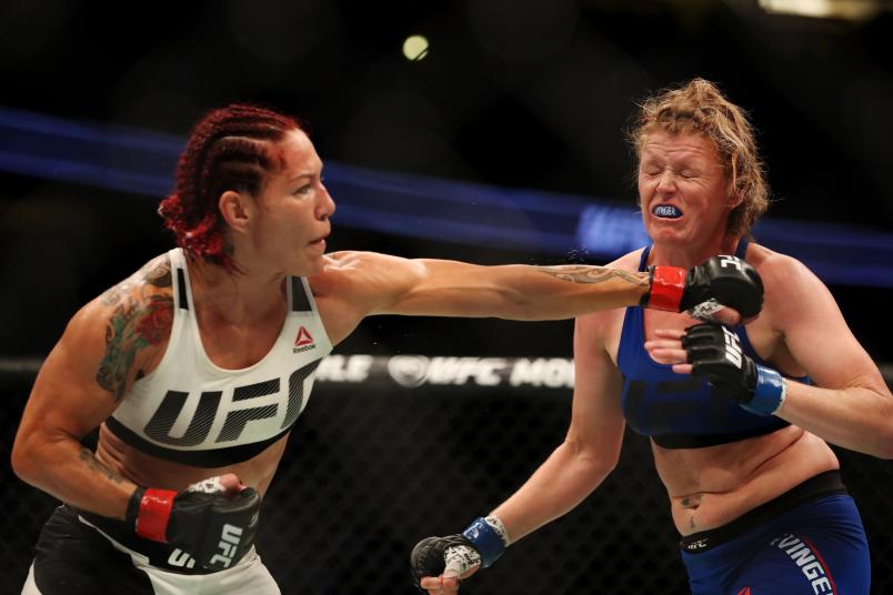 Cris Cyborg punches Tonya Evinger in their UFC women's featherweight championship bout during the UFC 214 event at Honda Center on July 29, 2017 in Anaheim, California.