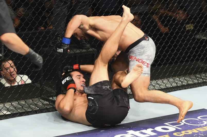 BOISE, ID - JULY 14: (R-L) Chad Mendes punches Myles Jury after knocking him down in their featherweight fight during the UFC Fight Night event inside CenturyLink Arena on July 14, 2018 in Boise, Idaho. (Photo by Josh Hedges/Zuffa LLC/Zuffa LLC via Getty Images)