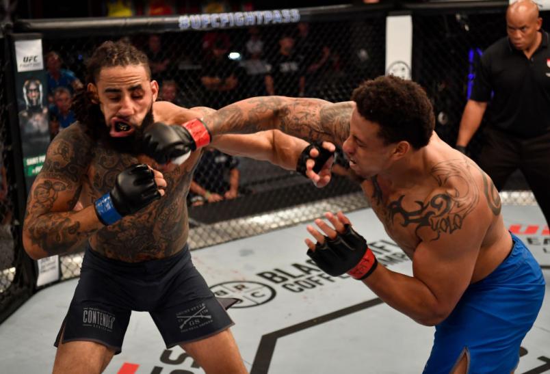 LAS VEGAS, NV - JUNE 12: (R-L) Greg Hardy punches Austen Lane in their heavyweight bout during Dana White's Tuesday Night Contender Series at the TUF Gym on June 12, 2018 in Las Vegas, Nevada. (Photo by Jeff Bottari/DWTNCS LLC)