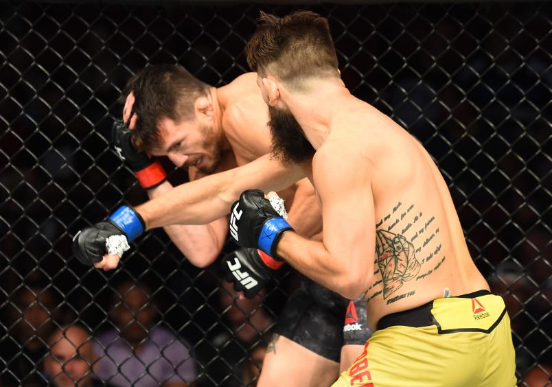 LINCOLN, NE - AUGUST 25: (R-L) Bryan Barberena punches Jake Ellenberger in their welterweight fight during the UFC Fight Night event at Pinnacle Bank Arena on August 25, 2018 in Lincoln, Nebraska. (Photo by Josh Hedges/Zuffa LLC/Zuffa LLC via Getty Images)