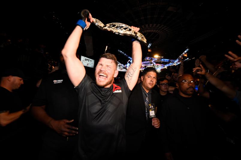 INGLEWOOD, CA - JUNE 04: Michael Bisping of England celebrates with his title belt after his first round knockout win against Luke Rockhold during the UFC 199 event at The Forum on June 4, 2016 in Inglewood, California. (Photo by Jeff Bottari/Zuffa LLC/Zuffa LLC via Getty Images)