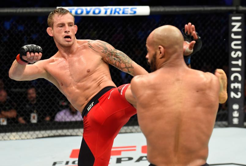 DALLAS, TX - MAY 13: (L-R) Krzysztof Jotko kicks David Branch in their middleweight fight during the UFC 211 event at the American Airlines Center on May 13, 2017 in Dallas, Texas. (Photo by Josh Hedges/Zuffa LLC/Zuffa LLC via Getty Images)