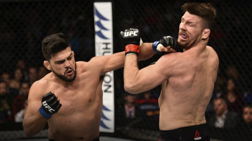 SHANGHAI, CHINA - NOVEMBER 25: Kelvin Gastelum punches Michael Bisping of England in their middleweight bout during the UFC Fight Night event inside the Mercedes-Benz Arena on November 25, 2017 in Shanghai, China. (Photo by Brandon Magnus/Zuffa LLC via Getty Images)