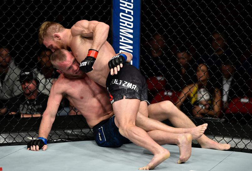 FRESNO, CA - DECEMBER 09: (R-L) Scott Holtzman punches Darrell Horcher in their lightweight bout during the UFC Fight Night event inside Save Mart Center on December 9, 2017 in Fresno, California. (Photo by Jeff Bottari/Zuffa LLC/Zuffa LLC via Getty Images)