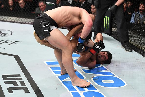Beneil Dariush attempts to submit Drew Dober