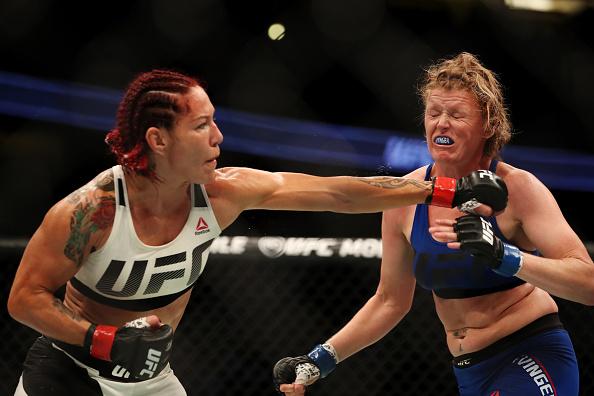 ANAHEIM, CA - JULY 29: Cris Cyborg of Brazil punches Tonya Evinger in their UFC women's featherweight championship bout during the UFC 214 event at Honda Center on July 29, 2017 in Anaheim, California. (Photo by Christian Petersen/Zuffa LLC/Zuffa LLC vi