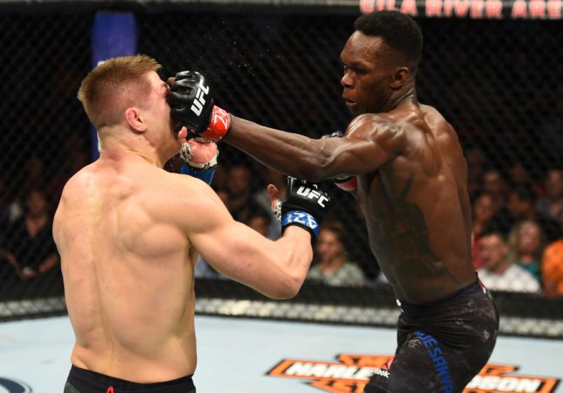 GLENDALE, AZ - APRIL 14: (R-L) Israel Adesanya of Nigeria punches Marvin Vettori of Italy in their middleweight fight during the UFC Fight Night event at the Gila Rivera Arena on April 14, 2018 in Glendale, Arizona. (Photo by Josh Hedges/Zuffa LLC/Zuffa