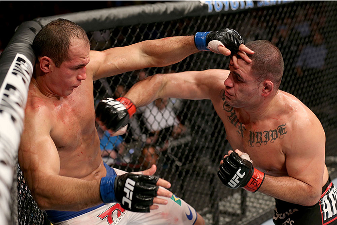 HOUSTON, TEXAS - OCTOBER 19: (R-L) Cain Velasquez punches Junior Dos Santos in their UFC heavyweight championship bout at the Toyota Center on October 19, 2013 in Houston, Texas. (Photo by Nick Laham/Zuffa LLC/Zuffa LLC via Getty Images)