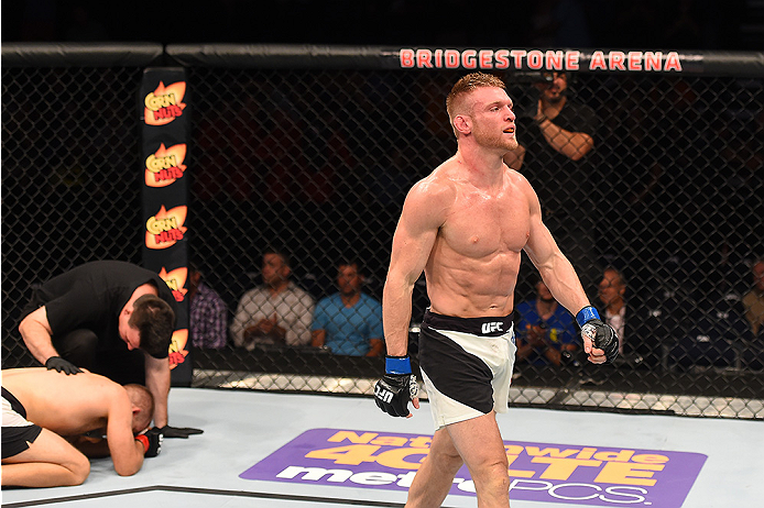 NASHVILLE, TN - AUGUST 08: (R-L) Scott Holtzman celebrates after defeating Anthony Christodoulou of Greece in their lightweight bout during the UFC Fight Night event at Bridgestone Arena on August 8, 2015 in Nashville, Tennessee. (Photo by Josh Hedges/Z